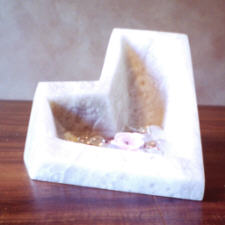 Alabaster sculture on a oak base with a glass bead and a floating rose candle